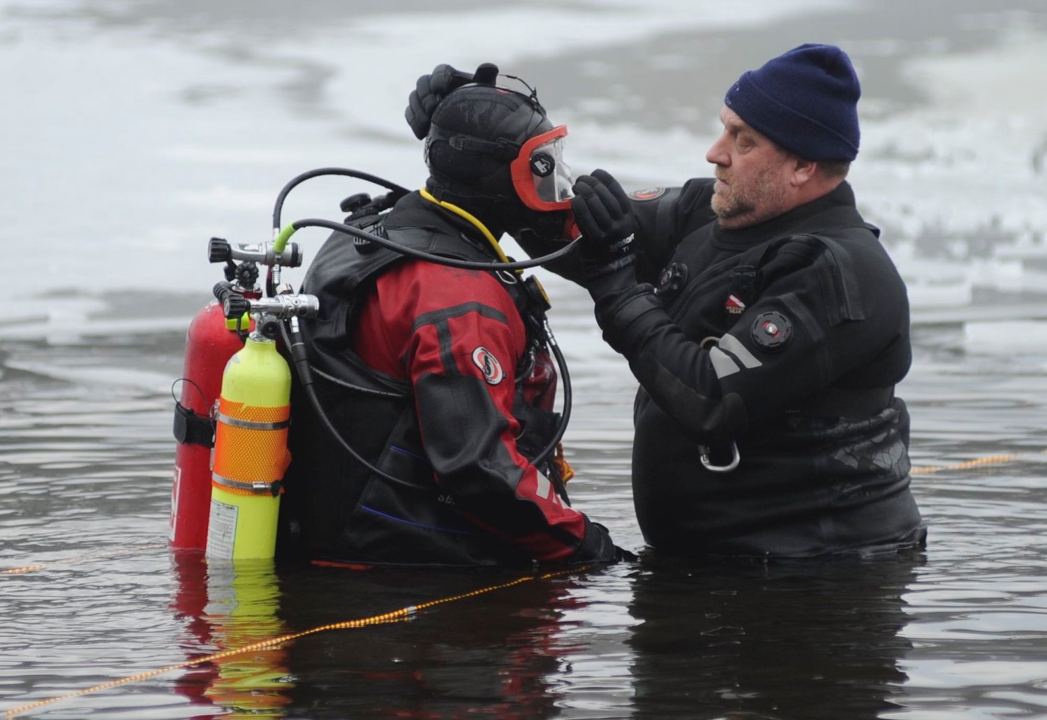 Brian Hulstlander of the Bloomingburg Fire Department served as the backup diver during the operation to pull a submerged four-wheeler out of the ice-covered lake. He is pictured having his diving equipment double checked by Joe Ratner, captain of the dive and rescue team.